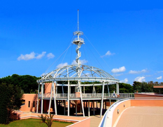 Blue Moon, Piazzale Bucintoro 1 – 30126 Lido Di Venezia. The Oxford Dictionary defines one meaning of symmetry as “similarity or exact correspondence between different things”. The ‘Blue Moon’ was designed by Giancarlo de Carlo (1919-2005), professor emeritus at the Venice School of Architecture (Università Iuav di Venezia), founded in 1926 as the Istituto Universitario di Architettura di Venezia. Giancarlo de Carlo saw the role of the architect as inherently political and lectured on the need for the inclusion of users in the design process. He criticised contemporary architectural practice and academic society for being preoccupied with form and glossy image over social and life experience. His designs exemplify the dynamism of what he saw as consensus based physical and cultural necessity. In designing social housing, for example, he took into account the wishes of the intended occupiers – perfect symmetry. For me, he is the Beat Poet of Modern Architecture. https://witness.theguardian.com/assignment/5564b046e4b0271ee9748b9b/1576658
