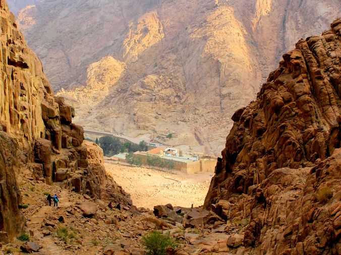 Approaching Saint Catherine’s Monastery, South Sinai Governorate, Egypt “James, stop photographing rocks and keep up!” The monastery was built between 548 and 565 and is one of the oldest working Christian monasteries in the world. Housing the world’s oldest continually operating library it possesses the Syriac Sinaiticus, a late 4th-century manuscript of 358 pages which contains a translation of the four canonical gospels of the New Testament into Syriac. Until 1859, it also housed the Codex Sinaiticus or “Sinai Bible” which is an ancient, handwritten copy of the Greek Bible, most of which is now held in the British Library, London. https://witness.theguardian.com/assignment/5645b219e4b04096fed8b8dd/1805765